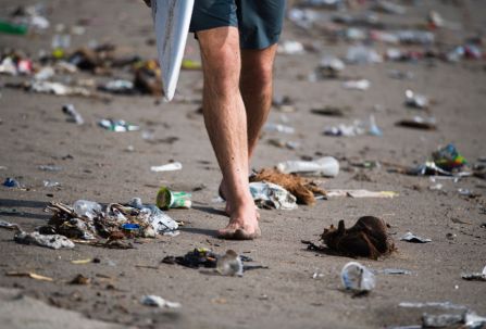 a surfer on a polluted beach